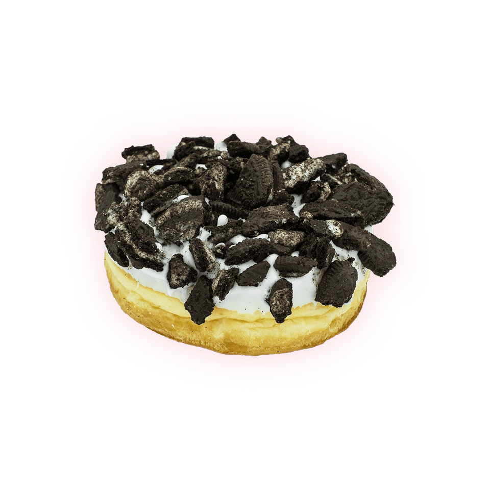 A Naughti Donut with white glaze piled high with crushed chocolate cookie